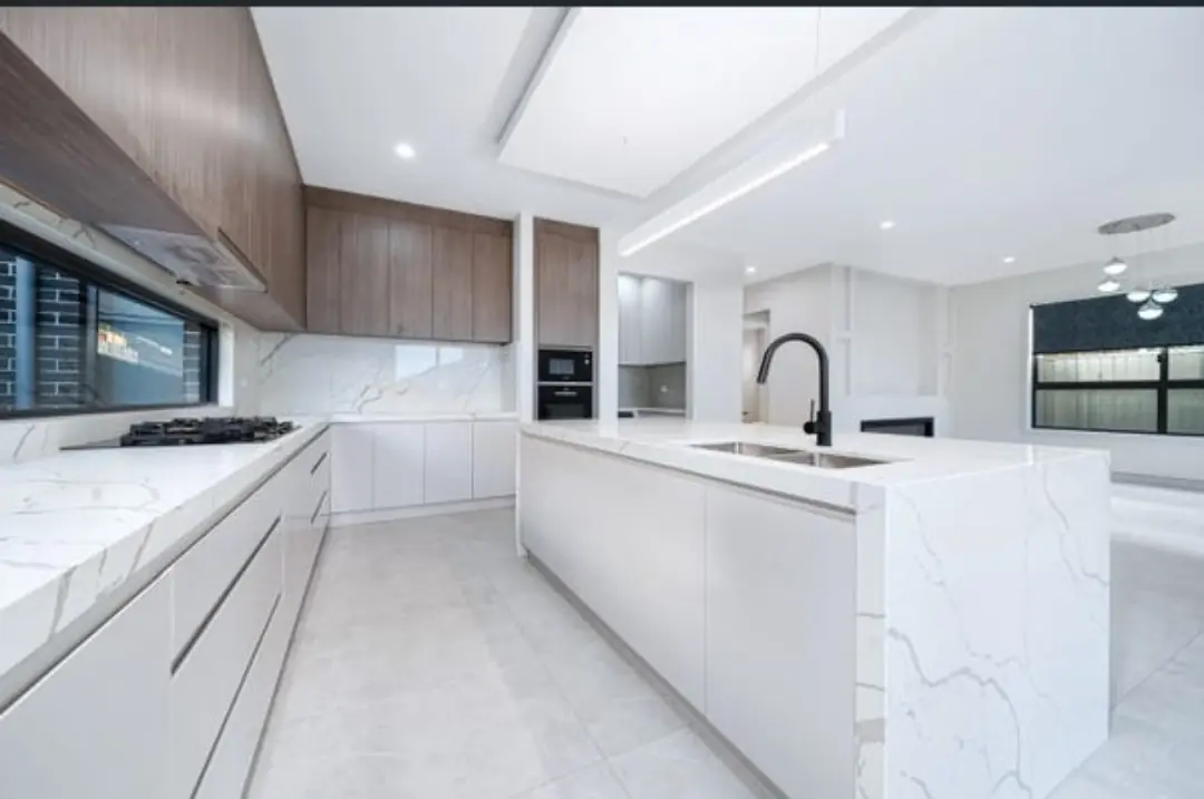 Modern kitchen with marble island completed by JB Prime Homes